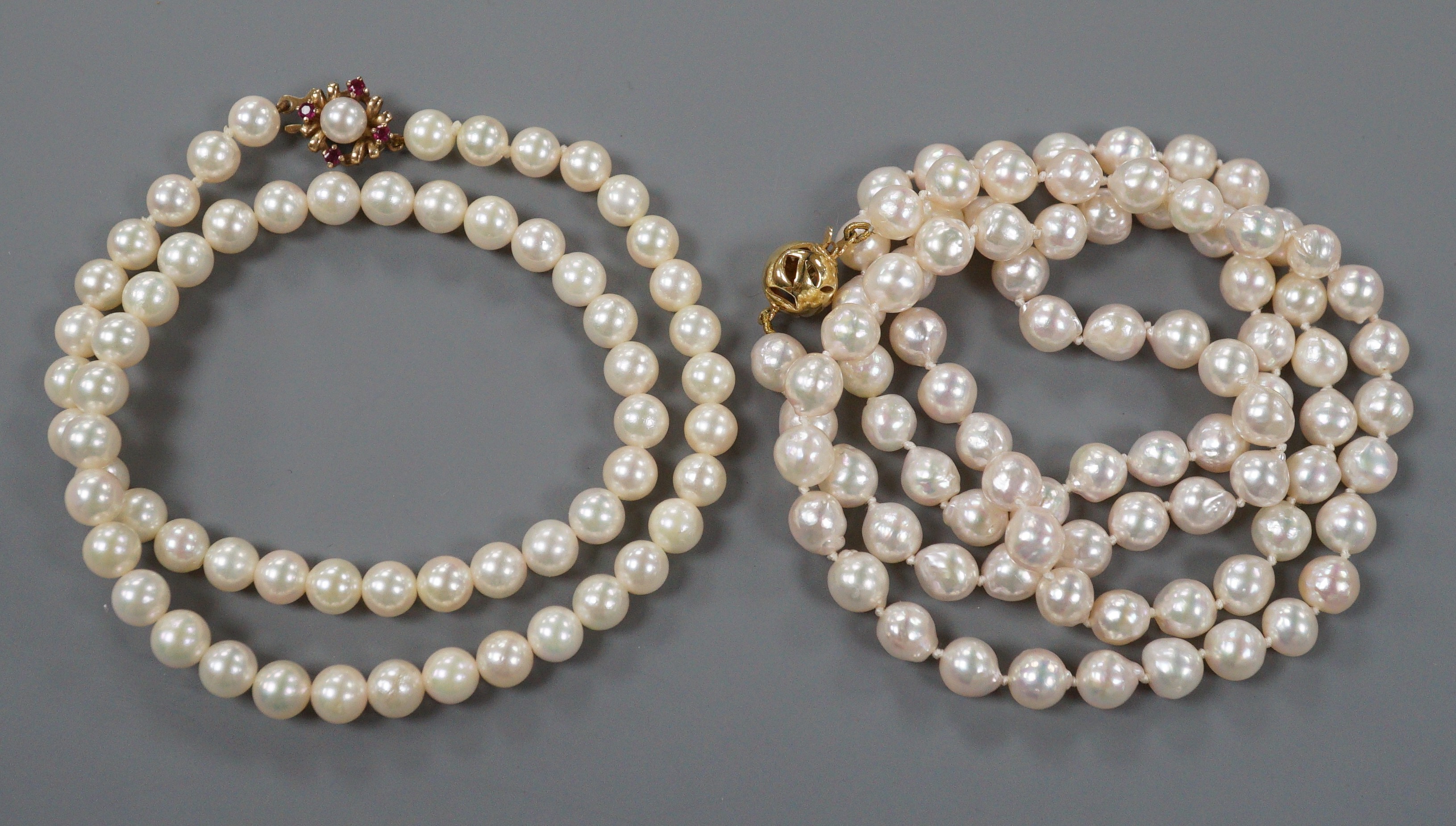 Two single strand cultured pearl necklaces, one possibly freshwater pearl?, both with 9ct gold clasps, largest 74cm.